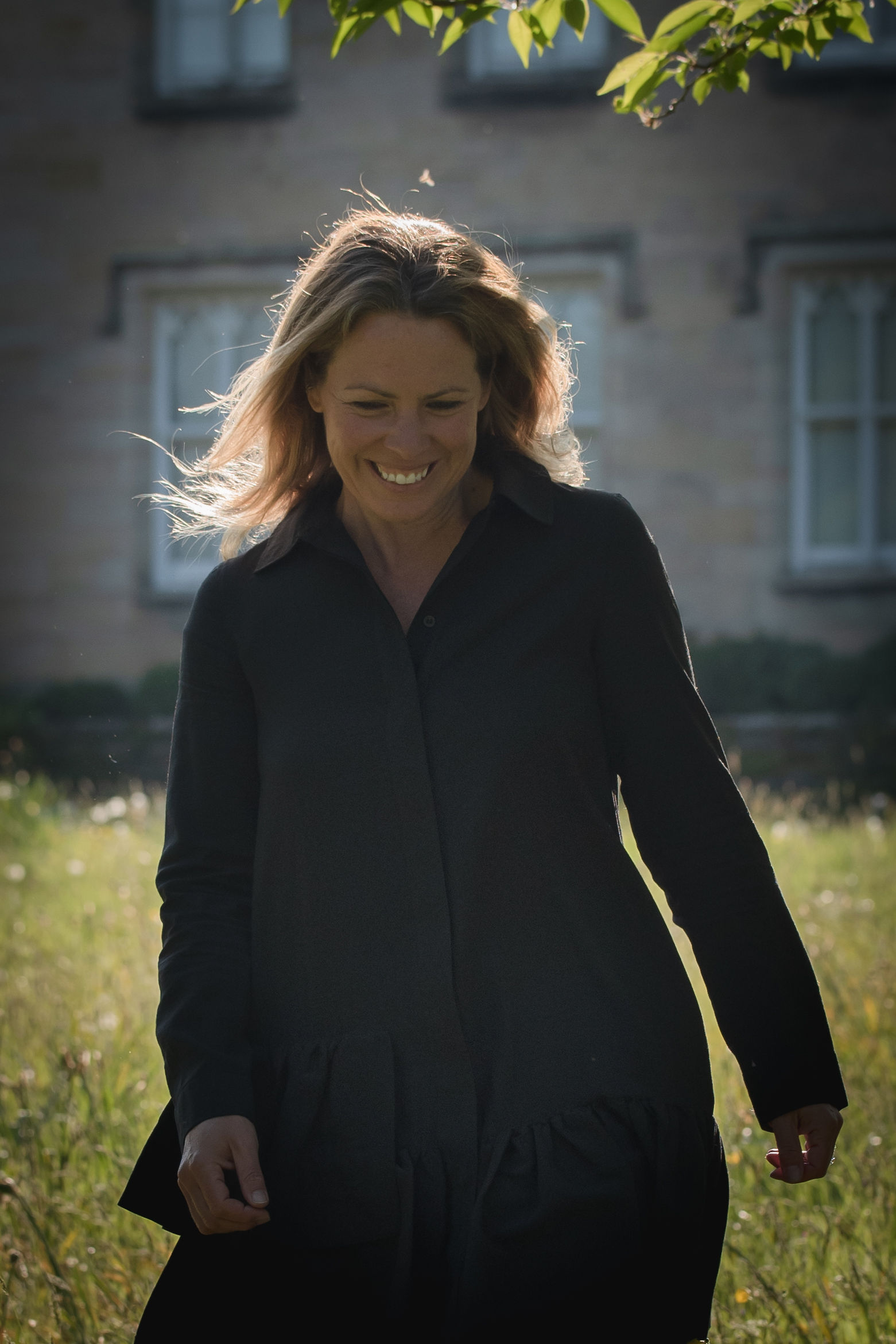 Mel walking through some grass